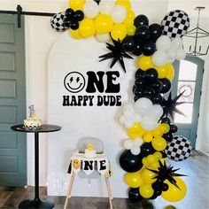 a birthday party with black and white balloons, one happy dude balloon arch and checkerboard backdrop