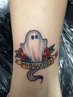 a tattoo on the leg of a person with a ghost