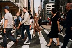 people crossing the street at an intersection in new york city