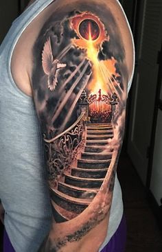 a man with a full sleeve tattoo on his arm and shoulder is standing in front of stairs