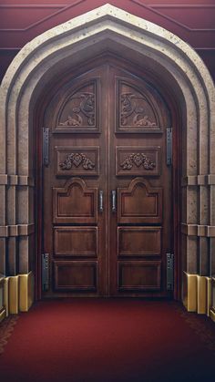 the entrance to an ornate building with two large wooden doors and red carpeted flooring