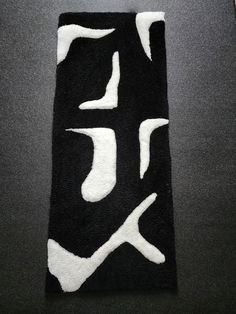 a black rug with white letters on it