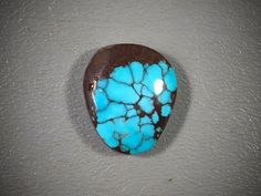 a blue and brown stone sitting on top of a table