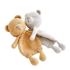 two crocheted teddy bears laying next to each other