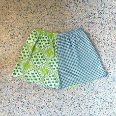 "Up cycled, repurposed, vintage fabric. Green and Blue Strawberry Print, mixed with a Blue and White print Size: XL Waist 31\" stretches to 52\"  Hips 54\"  Rise 14.5\" Inseam 4.5\" High waisted fit, contrasting side seam pockets. Elastic waist band .  Cotton, poly .  *fabric is repurposed may have slight wear . Each of these shorts are one of a kind with unique placement of fabric and colors.         From the Kiki42 label, handmade in Los Angeles CA." Green Cotton Bottoms For Daywear, Upcycled Blue Bottoms For Spring, Blue Cotton Upcycled Bottoms, Upcycled Cotton Blue Bottoms, Blue Upcycled Cotton Bottoms, Upcycled Blue Cotton Bottoms, Summer Green Shorts With Patchwork, Upcycled Bottoms For Summer, Blue Cotton Patchwork Shorts