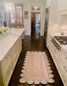 a kitchen with an area rug on the floor