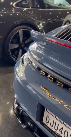 two porsches are parked in a showroom