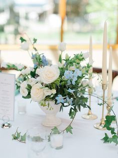 a table with candles and flowers on it