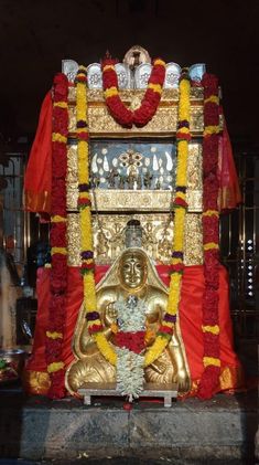 the shrine is decorated with red and yellow flowers