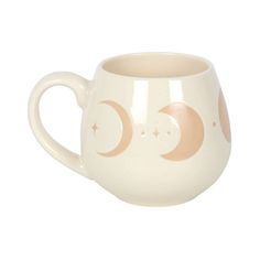 a coffee cup with two crescents and stars painted on the side, sitting in front of a white background