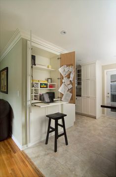 a room with a desk, chair and bookshelf on the wall in it