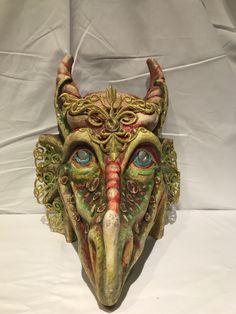 "Dragon Mask Size: one size Traditional and original papier-mache Venetian mask, handmade and decorated with acrylic colors and lace insert. This traditional Venetian mask shape is called \"Dragon mask\" and is a full face mask. All our masks are handmade papier-machè masks, made in Venice. Our decorators use techniques typical of the Venetian tradition such as stucco, acrylics, gold and silver-leaf, macramè, passementerie, pearls and crequelè to give you a wide range of masks. The mask could be Handmade Fantasy Masks For Masquerade, Handmade Artistic Masks For Carnival, Handmade Fantasy Masks And Prosthetics For Costume, Artistic Full Face Masks For Mardi Gras, Artistic Full Face Costume Mask, Handmade Fantasy Masks And Prosthetics For Carnival, Artistic Hand Painted Masks For Carnival, Artistic Masks And Prosthetics For Mardi Gras Costume, Artistic Masks For Costume Festivals