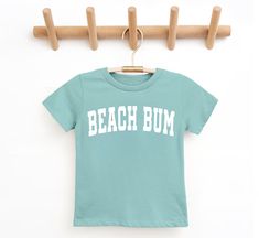 Details Beach Bum Kids Saltwater T-Shirt Fabric has stretch It offers superior comfort and a great fit. Short sleeve style with a crew neckline Pair this tee with a cute bow and sunnies Material and Care 100% Cotton Materials may have natural variations Colors may vary from different viewing devices. Playful Beach T-shirt For Spring, Playful T-shirt For Beach In Spring, Playful T-shirt For Summer Adventures, Playful Crew Neck T-shirt For Beach, Fun Cotton T-shirt For Summer Activities, Playful Letter Print Beach Top, Playful Letter Print Top For Beach, Fun Summer Cotton Tops For Activities, Cotton Crew Neck Top For Summer Activities