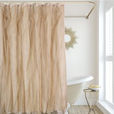 a bath room with a tub and a shower curtain