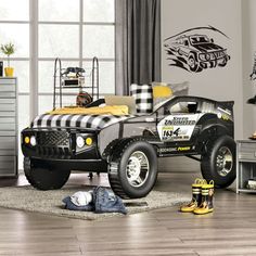 a black and white monster truck bed in a bedroom