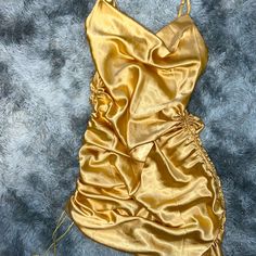 Gold Satin Spaghetti Strap Dress Size Small. Adjustable Length From Ankle Length To Mini Dress With Scrunchy Sides. Never Worn Gold Sleeveless Ruched Mini Dress, Ruched Cami Mini Dress For Party, Party Cami Dress With Ruched Details, Gold Satin Mini Dress For Summer, Gold Mini Dress With Spaghetti Straps For Summer, Gold Spring Dress With Spaghetti Straps, Gold Spaghetti Strap Dress For Summer, Gold Spaghetti Strap Mini Dress For Date Night, Gold Spaghetti Strap Summer Dress