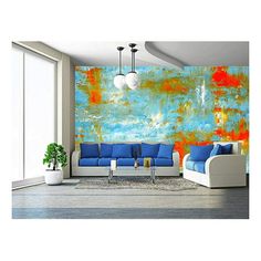 a living room with blue couches and an orange painting on the wall behind them