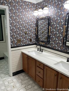 a bathroom with two sinks and mirrors in it