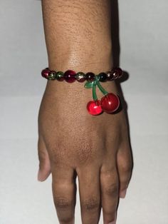 Cherry Bomb bracelet is made with red and green small beads, with 4 big red crackle beads and a cherry charm.  Can be bought with a set of cherry inspired earrings to match. Red Cherry Print Jewelry For Gifts, Trendy Cherry Adjustable Jewelry, Trendy Adjustable Cherry Jewelry, Cherry Beaded Round Bead Jewelry, Handmade Cherry Colored Round Bead Jewelry, Kitschy Jewelry, Red Crackle, Cherry Charm, Weird Jewelry