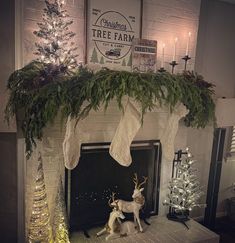 a fireplace decorated for christmas with stockings and deer figurines