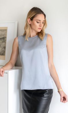 Meet the perfect silk shell top. This elevated silk tank can be worn alone or under your favorite blazer – you'll look equally fabulous either way. Elegant and classy with a versatile and minimalist silhouette. Wear on its own or pair with a blazer. Minimalist gold button and keyhole closure on the back. Hits just below the hips with side slits. Great tucked or untucked. 100% ULTRA-PREMIUM SATIN CHARMEUSE SILK – Washable Elegant Sleeveless Tank Top, Elegant Tank Top For Spring, Classic Sleeveless Top For Night Out, Elegant Summer Tank Top For Workwear, Classic Silk Top For Night Out, Sleek Sleeveless Formal Tops, Elegant Layering Tops For Summer, Chic Formal Tank Top For Spring, Chic Formal Spring Tank Top