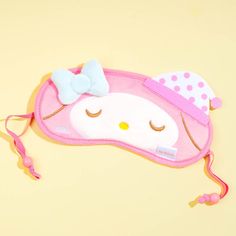 a hello kitty sleeping mask with a bow on it