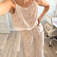 RELAX IN STYLE Get comfy and cute with this Floral Cami Pajama Set! The soft, ruffled pants and breathable cami top make it perfect for lounging or a good night’s sleep. It’s your new favorite way to relax. FABRIC THAT MOVES WITH YOU Made from soft fabric, it moves with you and feels great against your skin. The elastic waist pants add extra coziness, perfect for relaxing or sleeping in comfortable, flexible style. QUALITY AND ELEGANCE IN ONE This 2-piece pajama set with frills boasts a floral d Cute Ruffled Sleepwear For Bedtime, Cute Sleepwear With Ruffles For Bedtime, Cute Ruffled Sleepwear For Sleepover, Cute Ruffled Sleepwear For Loungewear, Casual Ruffled Sleepwear For Pajama Party, Spring Ruffled Sleepwear For Loungewear, Spring Ruffled Pajamas For Pajama Party, Cute Sleeveless Sleepwear For Loungewear, Casual Ruffled Sleepwear For Loungewear