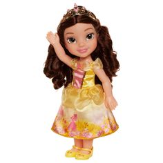 the doll is wearing a yellow dress with pink flowers on it's chest and brown hair