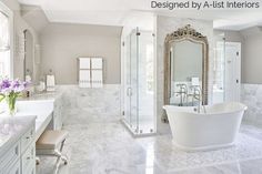 a large bathroom with marble floors and white fixtures, along with a claw foot tub