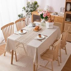 a dining room table with plates and cups on it