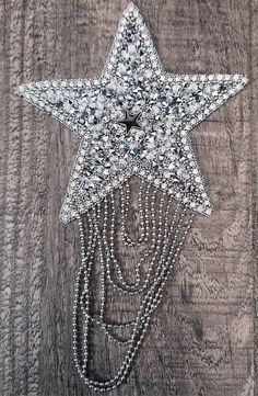 a star with chains attached to it on a wooden surface