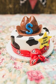 a birthday cake with a cowboy hat on top