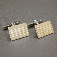 Presenting a pair of vintage 835 silver cufflinks with gold-wash finish. These elegant men's cufflinks feature rectangular-shaped buttons adorned with machine-etched ornament, showcasing a classic mid-century design. The geometric decor lends a sense of refinement and character, making them a versatile choice for both formal and casual occasions. Whether worn with a suit or a smart casual ensemble, these cufflinks are sure to enhance any outfit with their vintage charm.  The cuff links will be s Engraved Yellow Gold Cufflinks, Classic Rectangular Cufflinks, Classic Rectangular Wedding Cufflinks, Classic Rectangular Cufflinks For Business, Classic Rectangular Cufflinks For Anniversary, Classic Gold Rectangular Cufflinks, Rectangular Cufflinks For Business, Polished Rectangular Cufflinks, Gold Rectangular Cufflinks For Anniversary