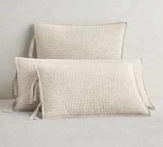 two white pillows sitting on top of each other