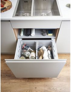 an open drawer in the middle of a kitchen