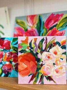 three paintings on a shelf with flowers painted on them