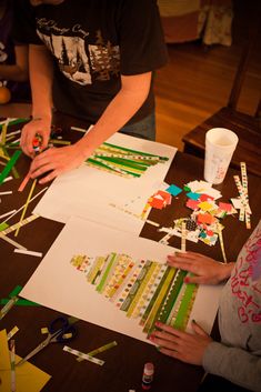 two children are making crafts on the table