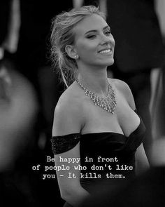 a woman wearing a black dress with a quote on it that says, be happy in front of people who don't like you if