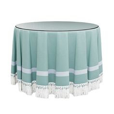 a round table with tasselled edges and fringe trim around the edge is shown in front of a white background