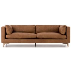 a brown leather couch sitting on top of a white floor next to a wooden frame