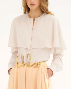 Chloe Pristine White Long Sleeve Layered Blouse Round neck Cape overlayer Long sleeves; button cuffs Concealed button down front closure Relaxed fit 100% silk Designer Long Sleeve Blouse With Blouson Sleeves, Designer Blouse With Blouson Sleeves, Elegant Long Sleeve Silk Crepe Blouse, Spring Formal Silk Crepe Blouse, Luxury Long Sleeve Spring Blouse, Luxury Long Sleeve Blouse For Spring, Timeless Silk Blouse For Daywear, Designer Long Sleeve Button Blouse, Designer Long Sleeve Blouse With Buttons