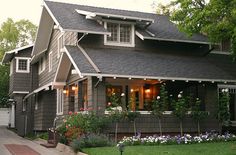 a house with flowers in the front yard