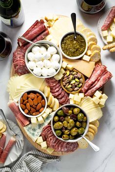 an assortment of cheeses and meats on a platter with the words making a simple cheese board