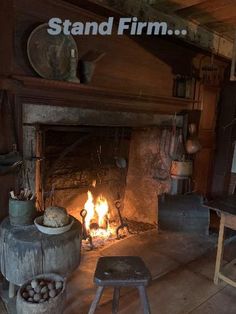 an old fireplace with logs and pots on it