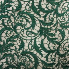 green lace fabric with an intricate design on it