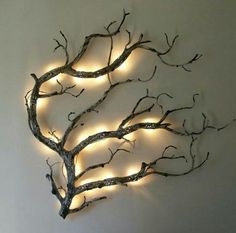 a tree with lights on it is mounted to the wall