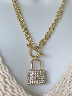 "18K Gold Toggle Necklace with Rhinestone Lock on one side and rows of small hearts on the other side. It's an eye catching piece to add to your jewelry collection. This chain and pendant give you two looks with one piece.  Beware wearing this may get you a lot of attention and compliments.  Chains (Gold or Silver) - Geometric link chain - 18K Plated - 21.06\" long   - Toggle closure (adds to the look) - Chunky chain - Chain is light weight Lock (Gold or Silver) - This is a unique lock one side has rhinestones and the other has small cut out hearts. Making it two different lock looks.  - 1.25\" H x 1.02\"L - Weight 59.4g Packaging & Shipping - Arrives in velvet pouch - Ships in bubble package - Please check estimated shipping arrival.  Remember your Sweetheart this Valentine's Day with jew Heart Lock Necklace, Necklace Lock, Lock Chain, Padlock Necklace, Chain And Pendant, Turquoise Drop Earrings, Lock Necklace, Heart Lock, Toggle Necklace