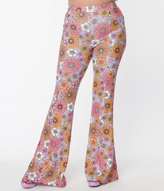 These sweet flare pants are crafted in a marvelous knit fabric that boasts green, orange, and pink retro florals throughout the lavender backdrop. Complete with zippered side pockets Available in sizes XS-4X while supplies last. Retro Stretch Bottoms With Floral Print, Trendy Flare Pants With Floral Print, Multicolor Bottoms With Retro Print For Spring, Retro Flare Pants With Floral Print, Retro Pink Bottoms With Floral Print, Retro Pink Floral Print Bottoms, Retro Flared Bottoms With Floral Print, Fitted Floral Print Hippie Bottoms, Retro Flared Pink Bottoms