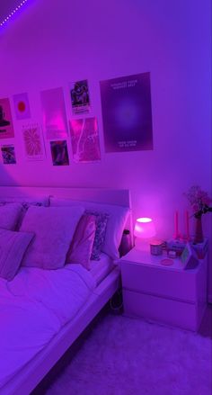 a bed room with a neatly made bed and purple lighting