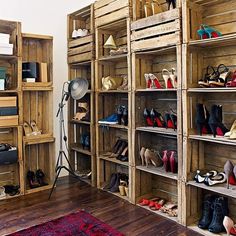 a room filled with lots of wooden shelves covered in pairs of high heels and shoes